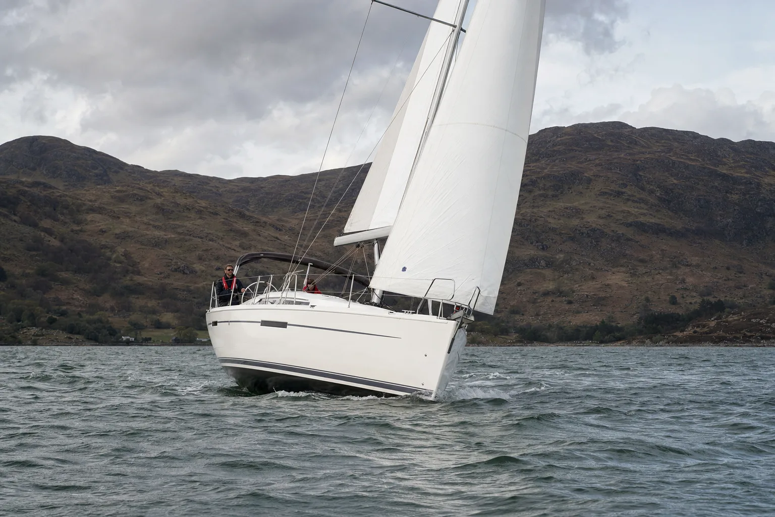 A cruising sailing yacht under sail in a Scottish sea loch
